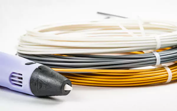 3d printing pen lie on three colorful rolled wires 2025 01 29 07 38 46 utc 6807ac1508130.webp